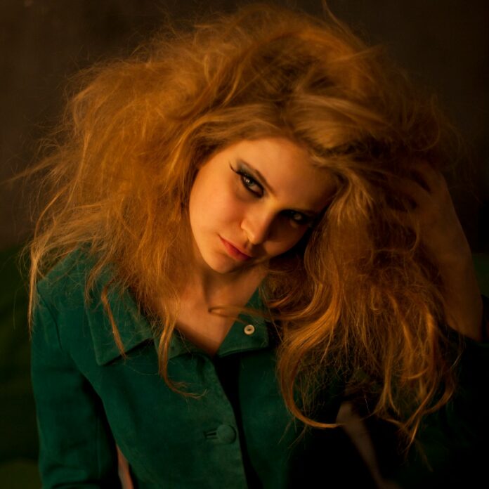 Photo by Kolos Kevei woman in green button up shirt wearing black framed eyeglasses