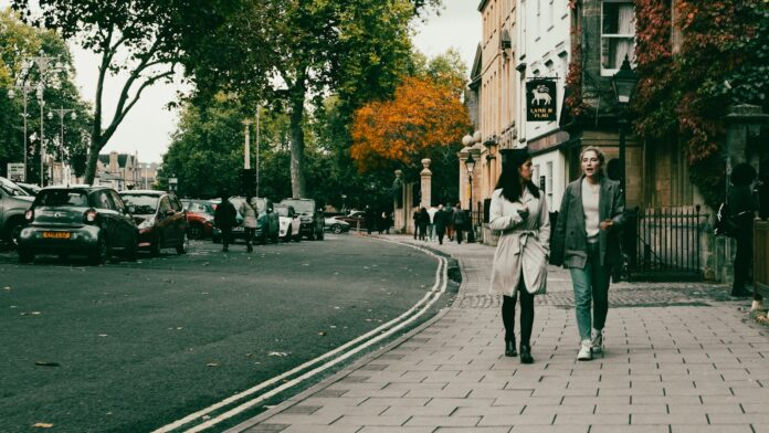 Photo by Metin Ozer a couple of people walking down a street