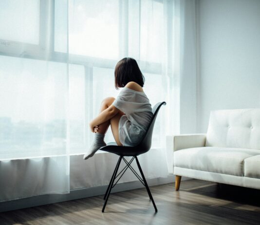 여성 건강의 새로운 관심사: 생애주기별 호르몬 변화와 생활습관 woman sitting on black chair in front of glass-panel window with white curtains