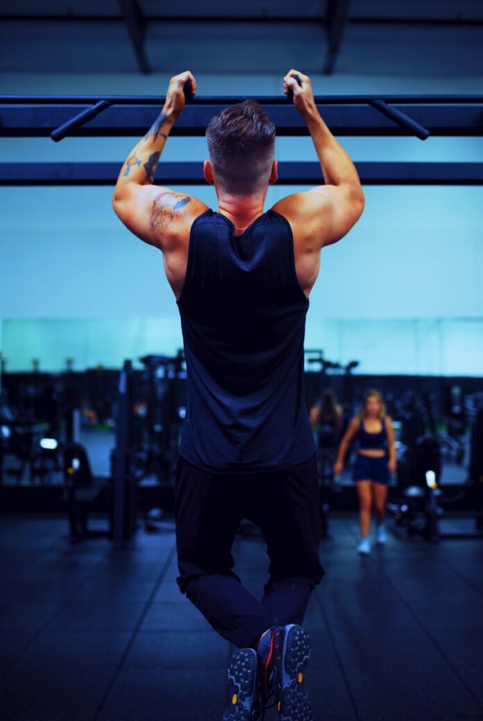 man in black t-shirt and black pants doing exercise